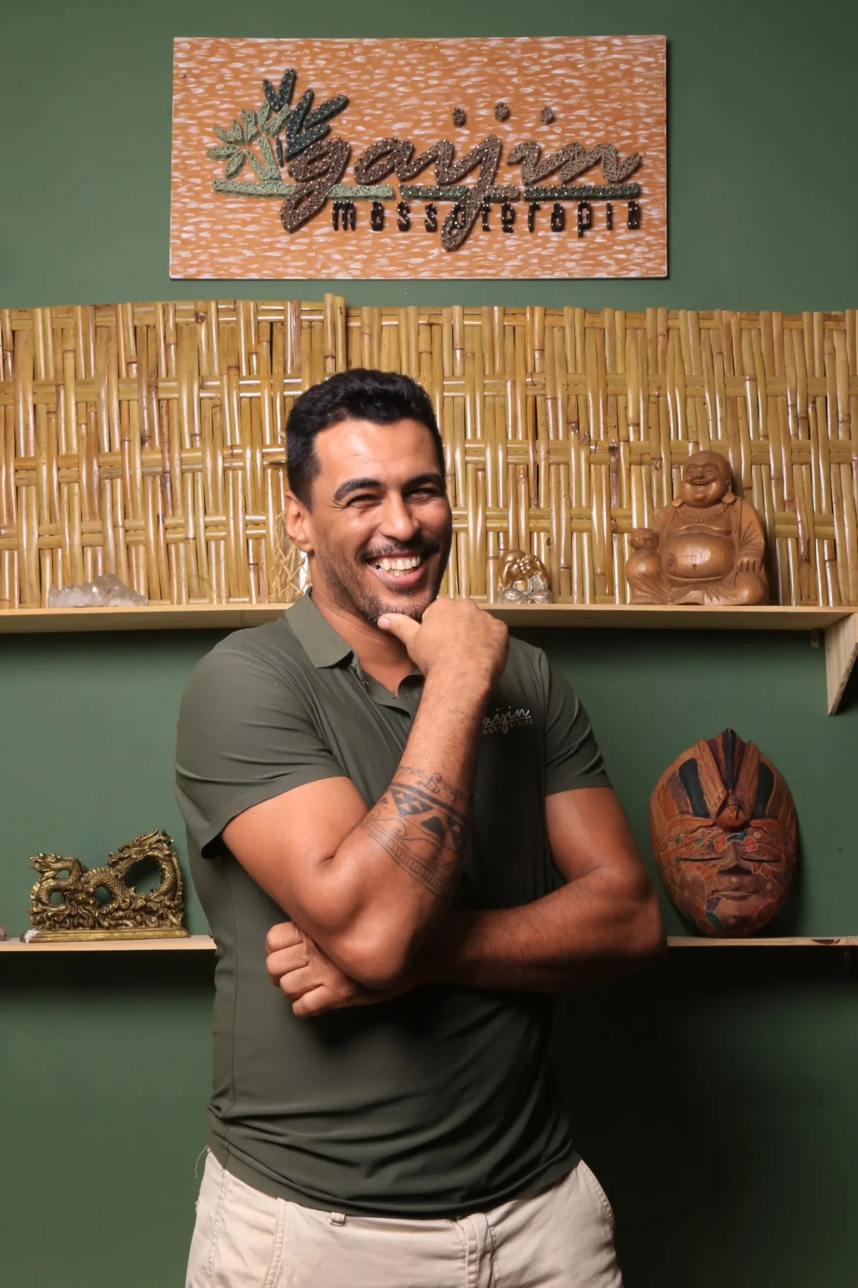 Carlos Rodrigues sorrindo, com o logo da Gaijin e painel de bambu ao fundo